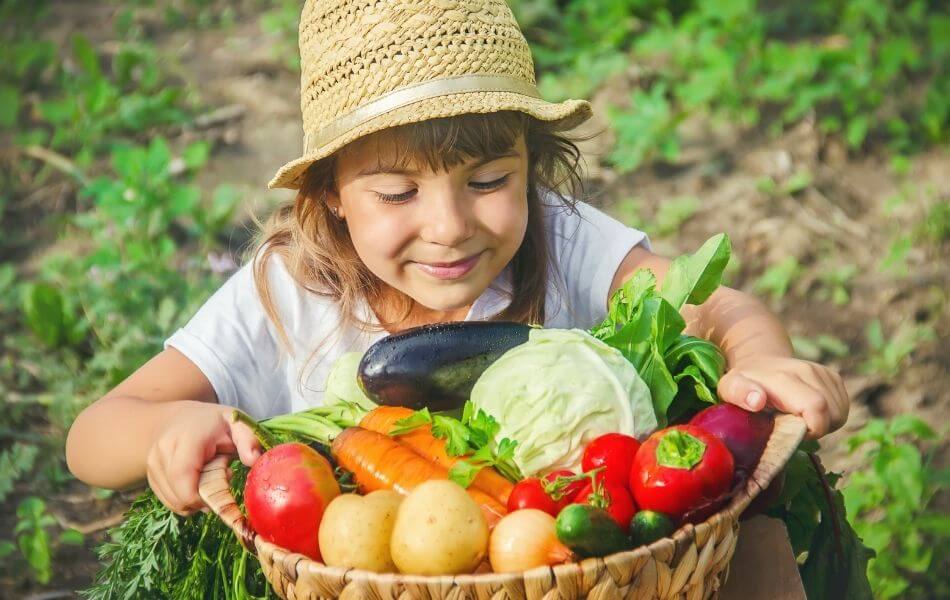 child picking vegetables